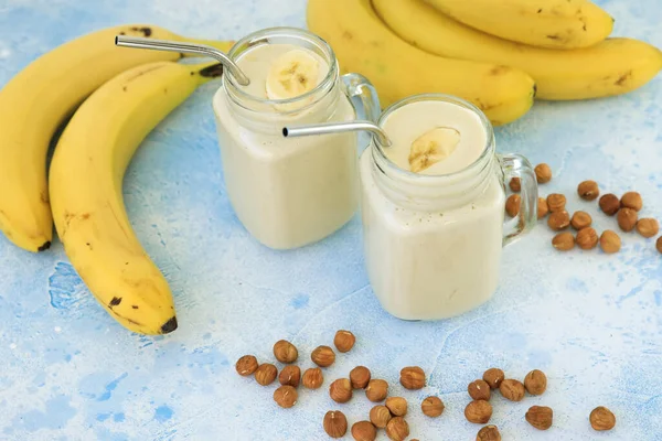 Banana smoothie with banana and nuts. Tasty vegetarian food, diet and healthy concept