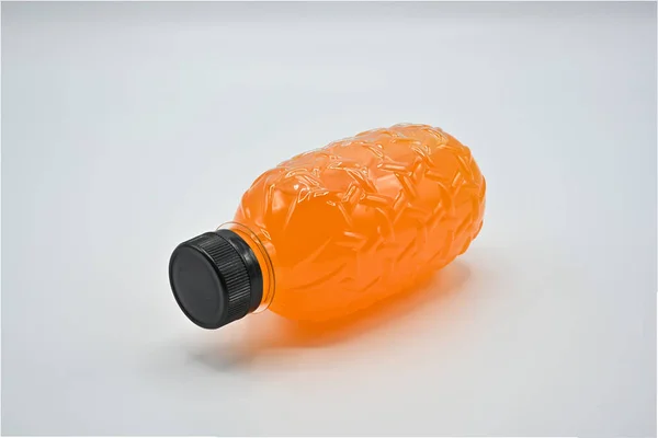 PET plastic bottles (Polyethylene terephthalate) black lid with fresh orange juice On a white background