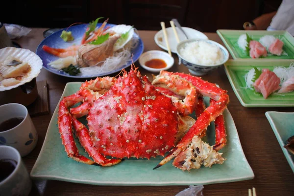 King Crab or whole Taraba crab, grilled and placed on a green plate is an expensive and spectacular Japanese meal.