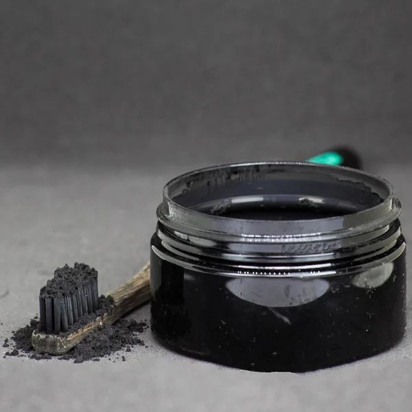 Charcoal on a toothbrush to whiten teeth — Stock Photo, Image