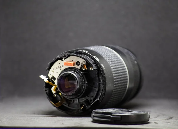 Part of camera lens isolated on black background broken — Stock Photo, Image