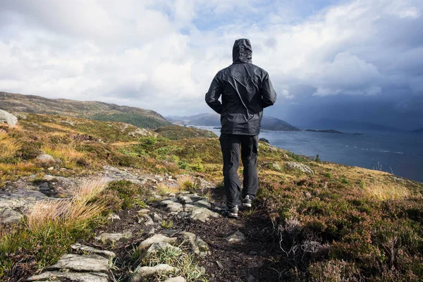 Wandelaar wandelen in de bergen op een regenachtige dag, doel, succes en vrijheid. Travling Noorwegen landschap — Stockfoto