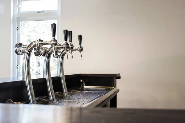 Beer tap in a row close-up in a pub, alcohol concept modern design — Stock Photo, Image