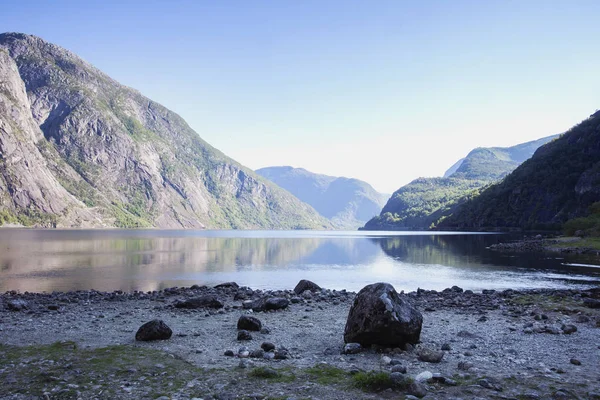Красивый пейзаж с высокими скалами, рекой и горами, спокойное озеро — стоковое фото