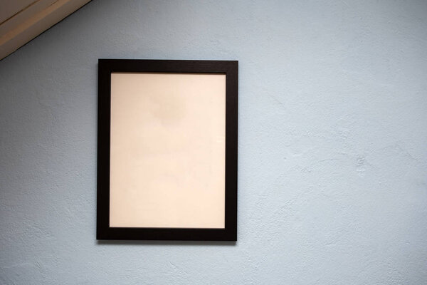 Mock up black frame on blue wall. background texture, space for text