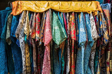 stack of traditional colourful sarong in a row on the market in Indonesia