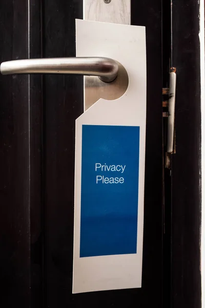 Label on door with the writing Privacy please in a hotel