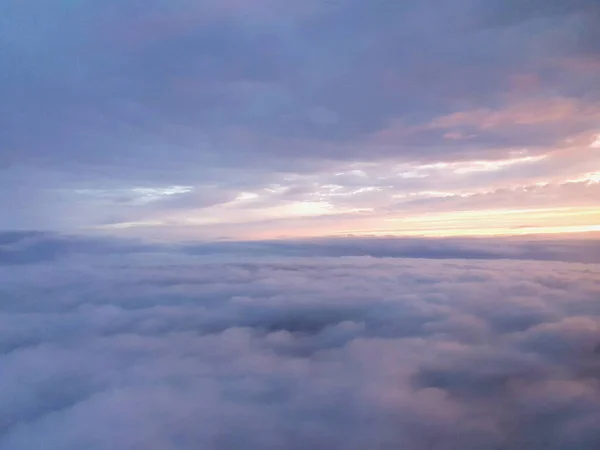 View from airplane window inside the clouds with colorful sunrise — Stock Photo, Image