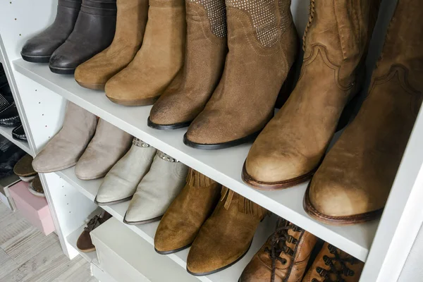 Collection of shoes sorted in shoe rack, brown colors, orginazed interior in a closed — Stock Photo, Image