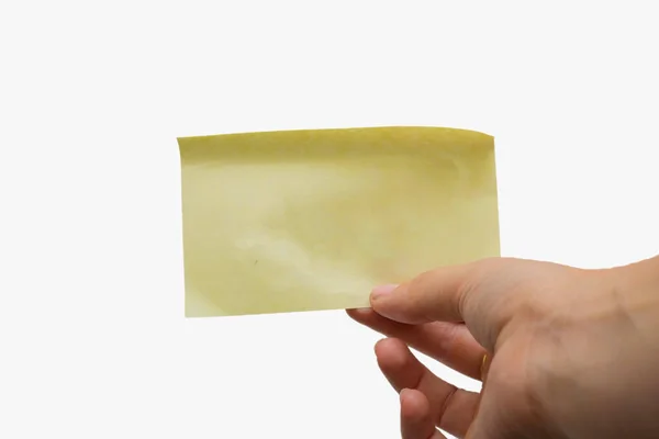 Woman holding a blank yellow sticky note isolated on white background, space for text — Stock Photo, Image