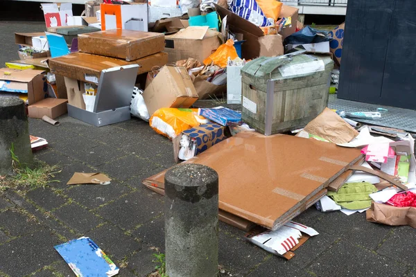 Gran pila de basura junto al contenedor lleno en la calle sucia, papel viejo —  Fotos de Stock