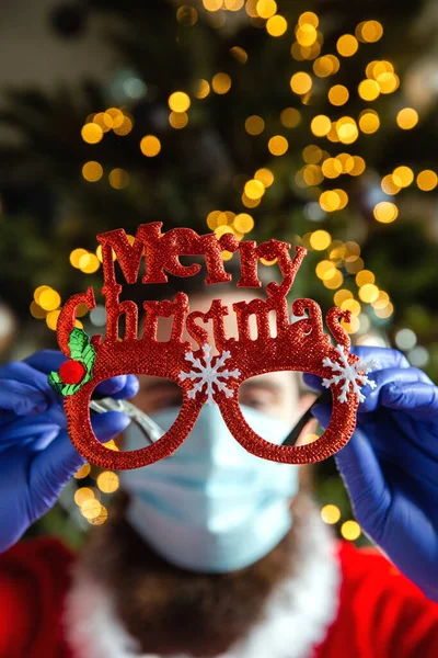 Mann mit Brille mit Frohe Weihnachten und Schutzmaske und Handschuhen gegen Coronavirus, Covid-19 und Feiertagskonzept — Stockfoto