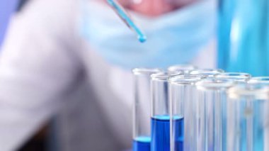 Pipet laboratuvar damla sıvı test tüpü içinde olan bilim adamı. Yakın çekim.