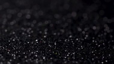 Siyah glitter doku döner. Parlak arka plan.
