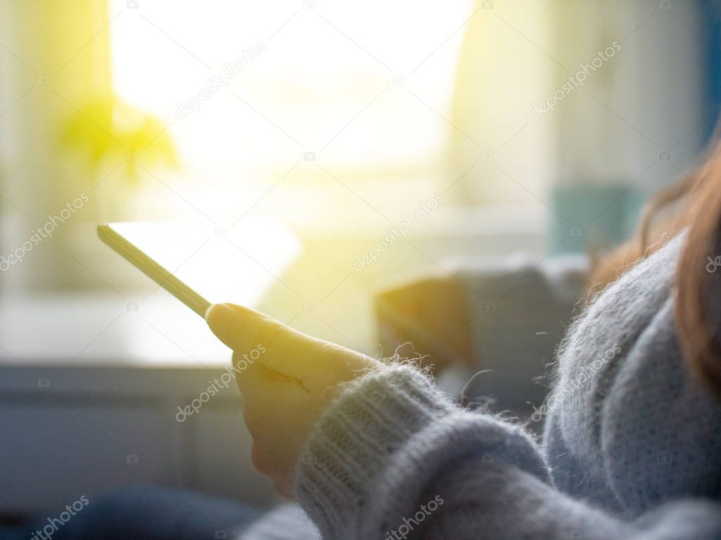 Young girl in blue sweater hold tablet and shopping online. Close up technology using.