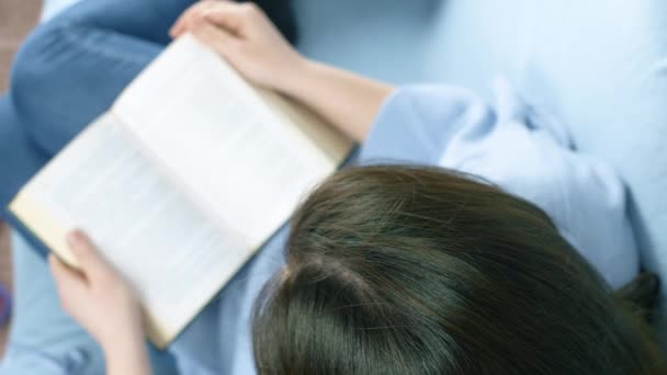 Young Girl Read Book Couch Close Slow Motion Footage — Stock Video