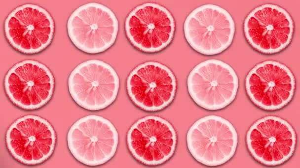 Abstract red color animation of sliced lemon and grapefruit on pastel background — Stock Video