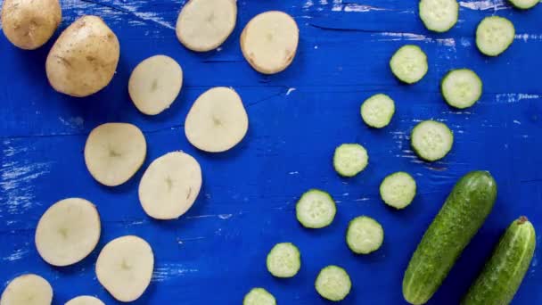 Abstract vegetable on blue wood surface stop motion footage. 4k animation seamle — Stock Video