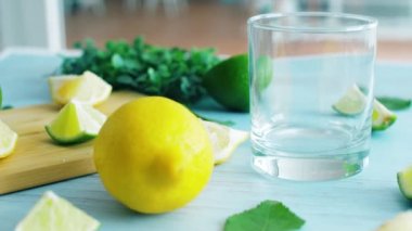 Cam ile ahşap mutfak yüzeyinde dilimlenmiş kireç ve limon. 4k görüntüleri kapatın.