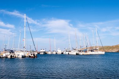 LOUTRA, Kythnos, Yunanistan. Güneşli bir günde, Loutra Marina Kythnos, Cyclades Adaları 'ndaki iskeleye demirlemiş yelkenli ve balıkçı tekneleri..