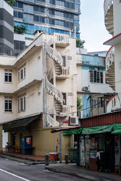 Singapore, 22/01/19. Old neglected white and blue buildings in Little India District in Singapore with spiral staircases and worn out paint.