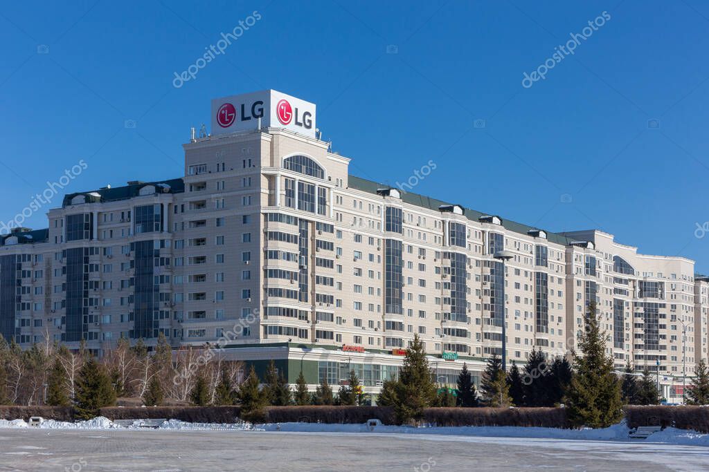 Astana, Kazakhstan, 29.01.22. Condominium Residential Complex Nursaya LG building with LG Electronics brand sign and square covered with snow, Dostyk Street, Astana, Kazakhstan.