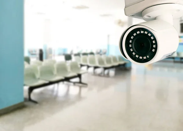 CCTV, security camera system operating in hospital with blurred image of empty chairs in waiting zone for pay money.