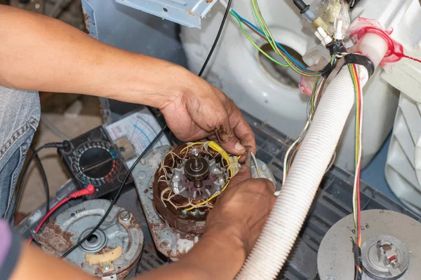 Technician repairing the washing machine motors