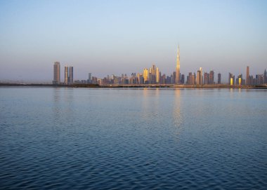 Dubai 'nin güzel bir şehrinin ufuk çizgisi üzerinde gün doğumu. Şehrin Jadaf bölgesinde ateş edilmiş. BAE. Açık havada.