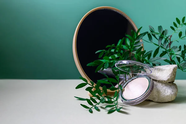 Mineral powder on a green background. Modern still life with copy space. Creative fashionable concept