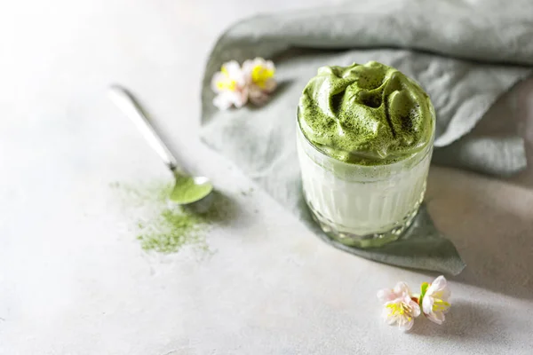 Match Dalgona Latte, Match cream, on a white background. Matcha green tea. Copy space, selective focus.