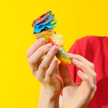 Bir elde renkli kek, yakın plan.