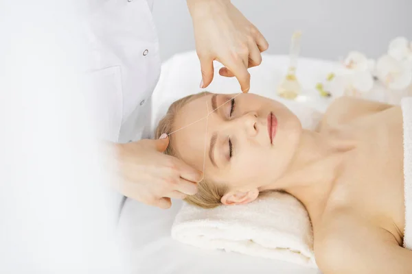 Beautiful caucasian woman getting face depilation procedure. Beauty and Spa salon concept — Stock Photo, Image