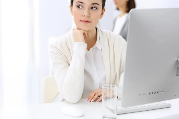 Mujer de negocios que trabaja con la computadora en la oficina, colega de fondo. Imagen de Abogado o Contador en el trabajo mientras está sentado en el escritorio —  Fotos de Stock