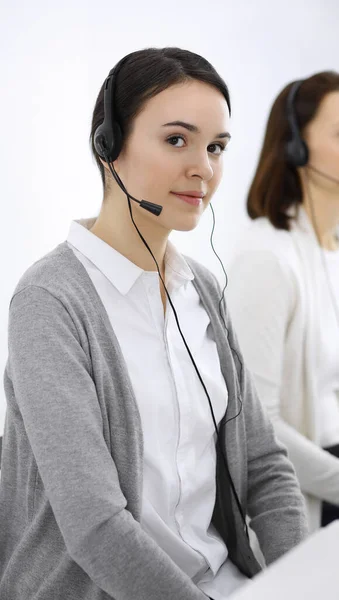 Call center. Casual dressed woman working in headset with diverse colleagues at office. Business concept — Stock Photo, Image