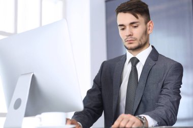 Modern ofiste bilgisayarla çalışan bir iş adamı. Arap erkek girişimcinin ya da iş yerindeki müdürün vesikalığı. İş konsepti