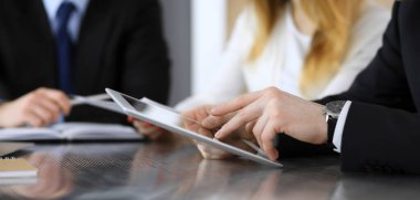 İş adamları ya da avukatlar modern ofiste yapılan toplantıda sözleşme sorularını tartışıyorlar, yakın plan. Bilinmeyen iş adamı ve iş arkadaşı cam masada oturan ve çalışan bir kadın. Takım çalışması ve