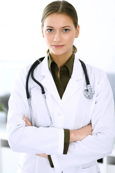 Doctora de pie recta y mirando a la cámara. Servicio médico perfecto en la clínica. Futuro feliz en medicina y salud — Foto de Stock