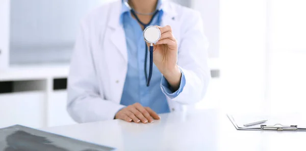 Doctor woman holds stethoscope head close-up. Physician ready to examine and help patient. Medical best treatment, medicine concept