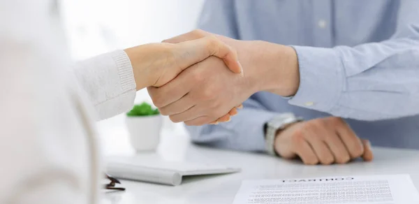 Casual geklede zakenman en vrouw schudden handen na het contract ondertekenen in wit gekleurd kantoor. Handdruk concept — Stockfoto
