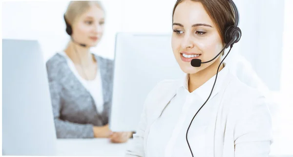 Call center. Group of diverse operators at work. Beautiful woman in headset communicating with customers of telemarketing service. Business concept — Stock Photo, Image