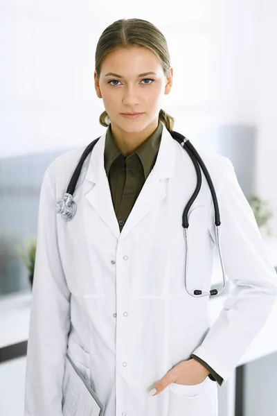 Mujer-médico de pie y mirando a la cámara. Servicio médico perfecto en la clínica. Medicina y asistencia sanitaria — Foto de Stock