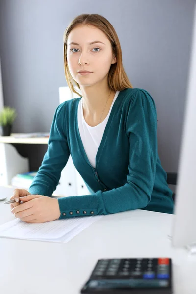Accountant checking financial statement or counting by calculator income for tax form, hands close-up. Business woman sitting and working at the desk in office. Audit concept — Stock Photo, Image