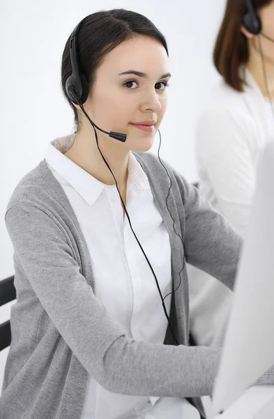 Call center. Casual dressed woman working in headset with diverse colleagues at office. Business concept — Stock Photo, Image