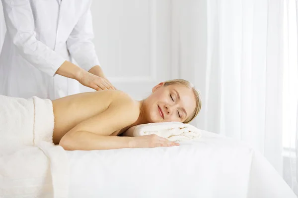 Piękna biała kobieta ciesząca się masażem pleców z zamkniętymi oczami. Koncepcja salonu piękności i spa — Zdjęcie stockowe