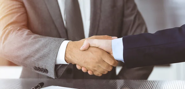 Unknown business people are shaking hands after contract signing in modern office, close-up. Handshake as successful negotiation ending — Stock Photo, Image