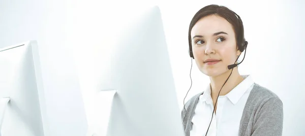 Call center. Casual dressed woman working in headset with diverse colleagues at office. Business concept — Stock Photo, Image