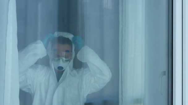 Tired Doctor Undress Protective Wear Looking Out Window — Stock Video
