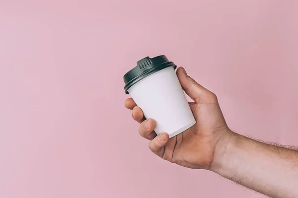 Logo ve tasarım için bir model. Bir adam elinde bir bardak kahve tutuyor.