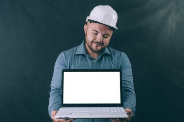 Elinde dizüstü bilgisayarla karanlık bir geçmişi olan miğferli bir adam. Model teknolojisi